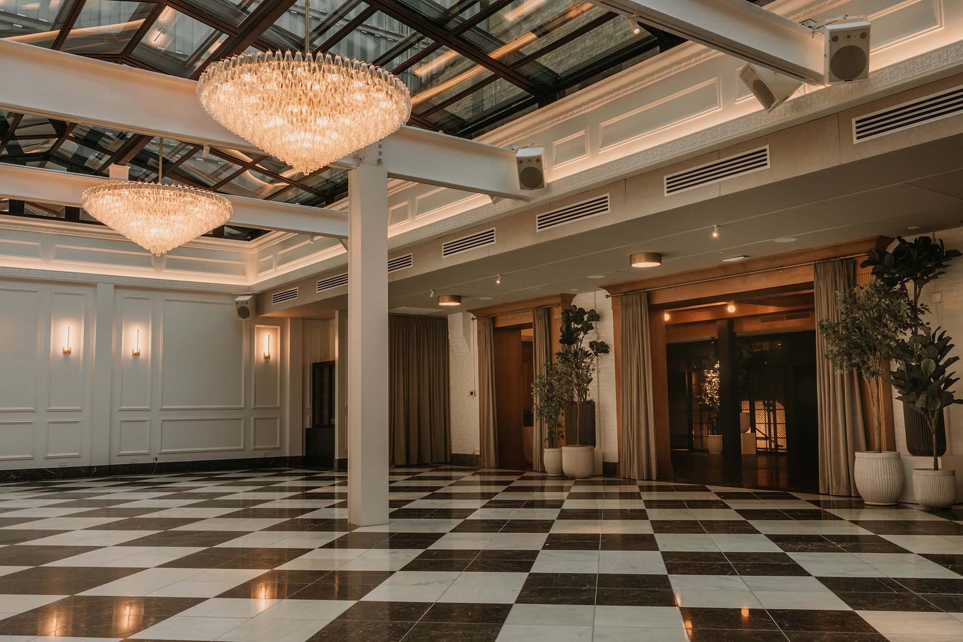 Checkered floor and chandeliers hanging overhead